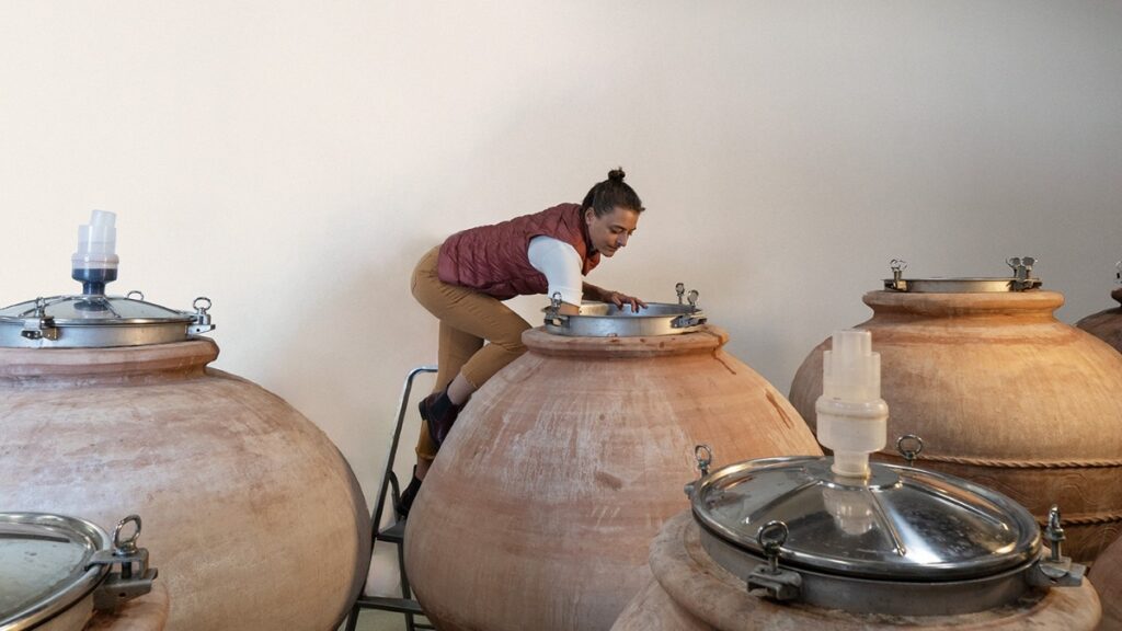 Elena Casadei aan het werk in grote terracotta wijnvaten